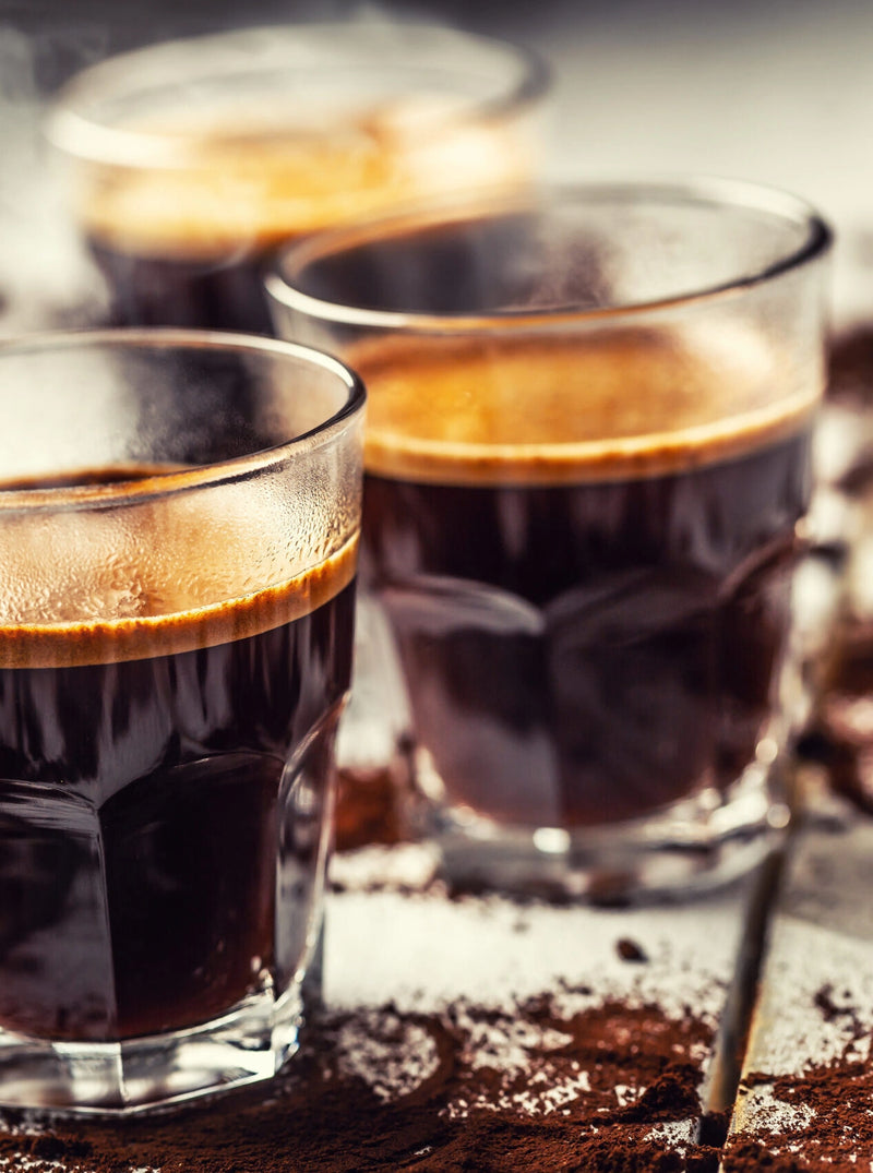 Turkish coffee in glass cups with spilled coffee beans